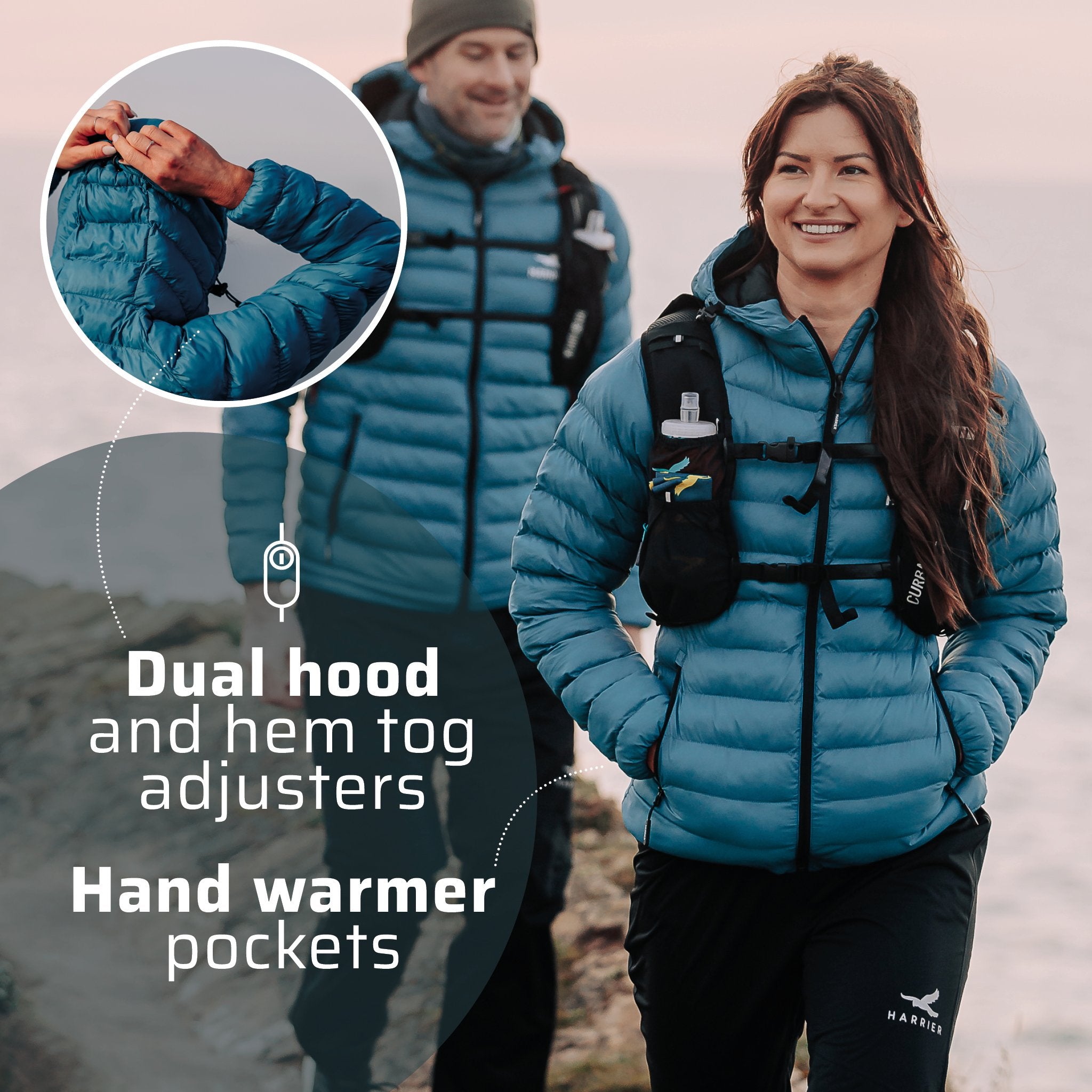 A woman and a man wearing the thermal jacket, walking along a coastline. They are smiling.