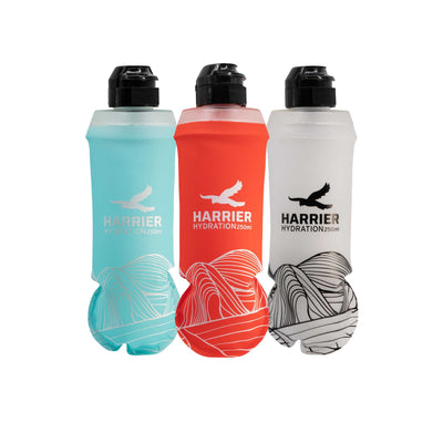 Three Harrier hydration bottles in blue, red, and white on a white background