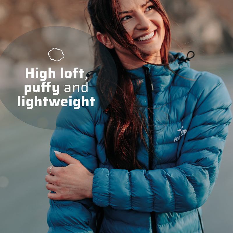 A woman wearing the thermal jacket, she is smiling. 