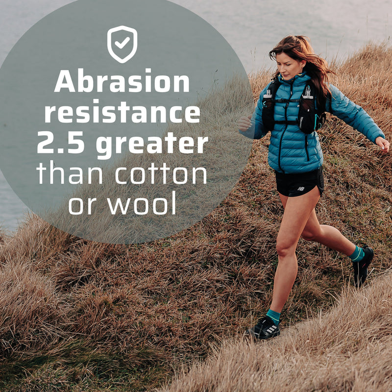 A woman running along a coastline. 