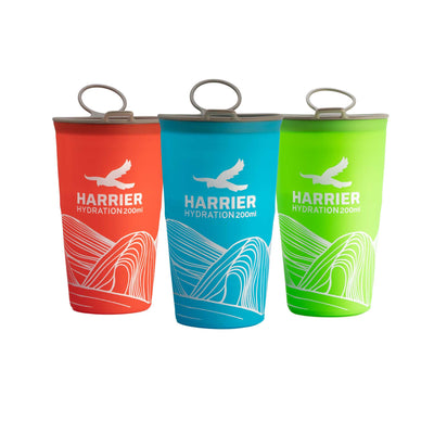 Three Harrier hydration cups in red, blue, and green on a white background