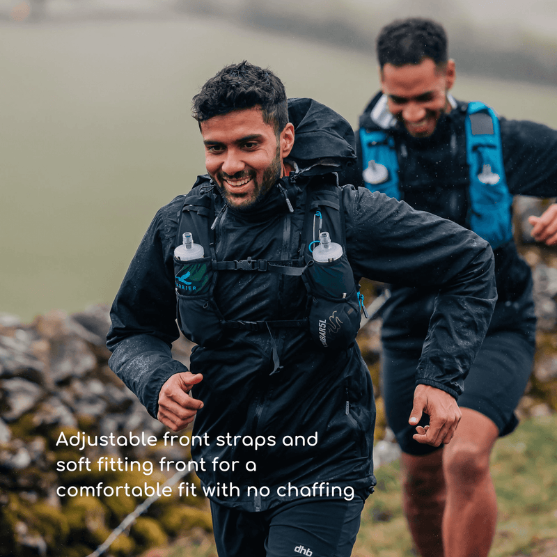 2 men wearing hydration vests running in the countryside. They are smiling. 