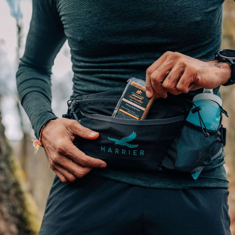 Close up of a man wearing the waist bag on his torso. 